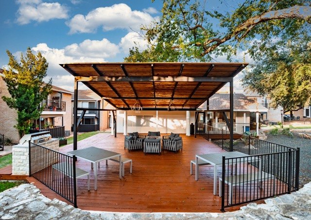 Covered pavilion with dining tables and a wood deck